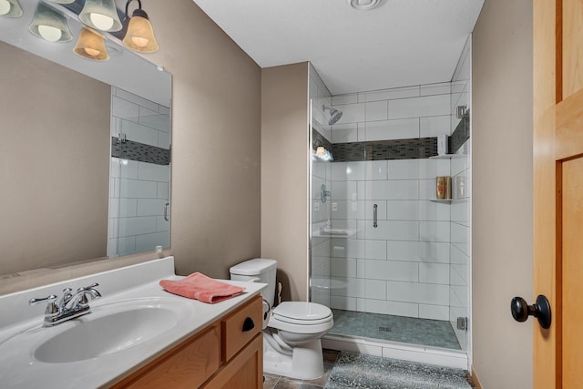 bathroom with an enclosed shower, vanity, and toilet