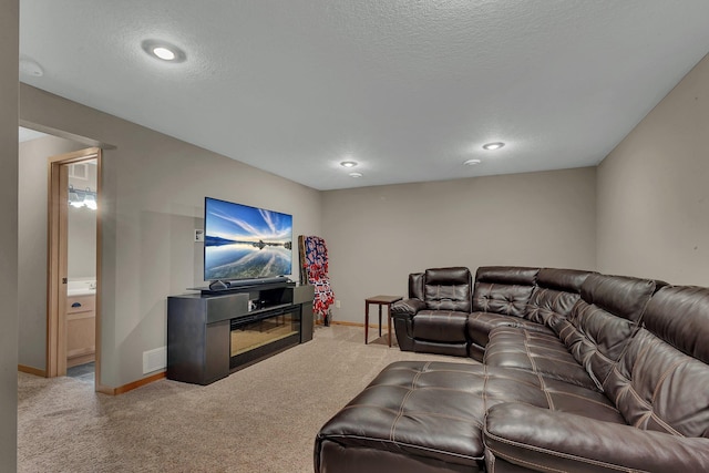 carpeted living room featuring a textured ceiling