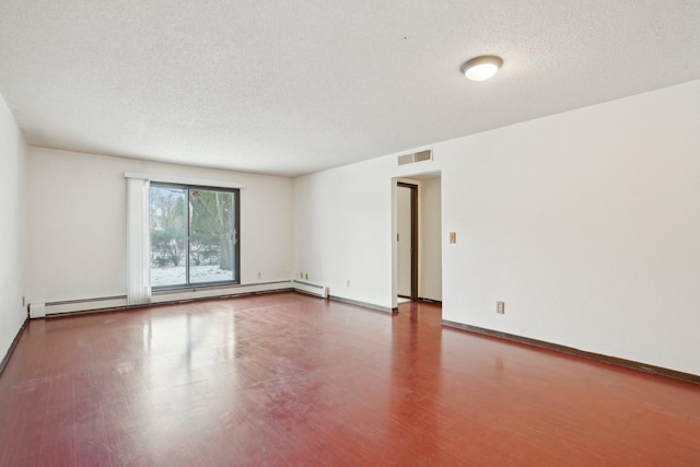 unfurnished room featuring wood-type flooring, a baseboard heating unit, and a textured ceiling