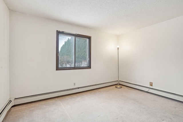 carpeted empty room with a baseboard heating unit and a textured ceiling