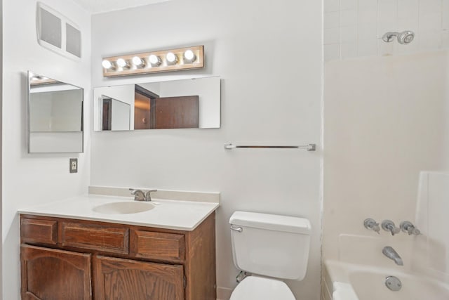 full bathroom featuring tiled shower / bath combo, vanity, and toilet