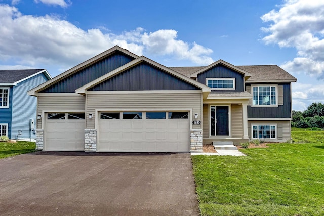 craftsman-style home featuring a garage and a front lawn