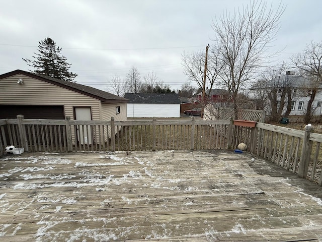 snow covered deck featuring a garage