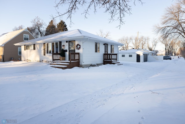 view of front facade featuring a garage and an outdoor structure