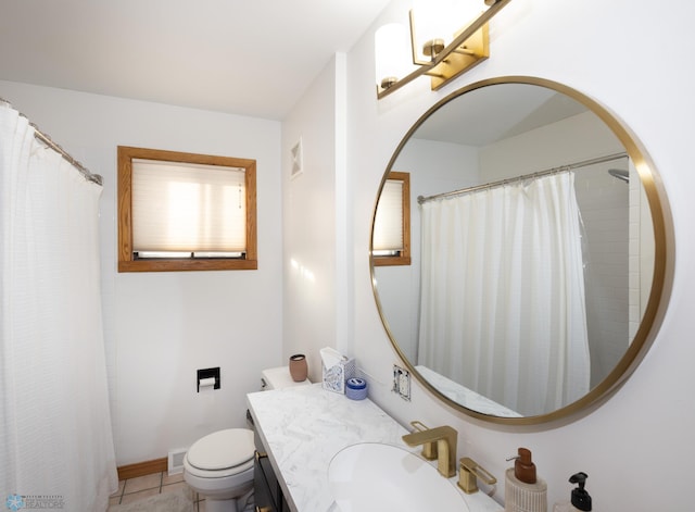 bathroom featuring tile patterned floors, toilet, and vanity