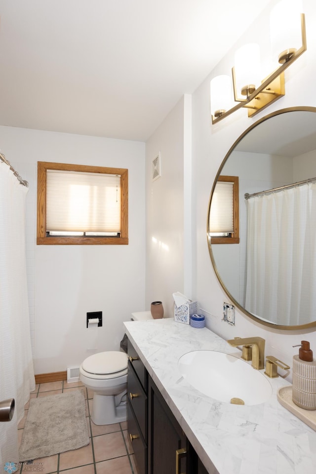 bathroom with vanity, tile patterned floors, and toilet