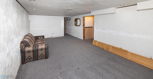 unfurnished room with carpet floors and a textured ceiling