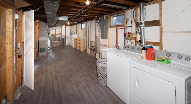 basement with dark wood-type flooring, electric panel, and independent washer and dryer