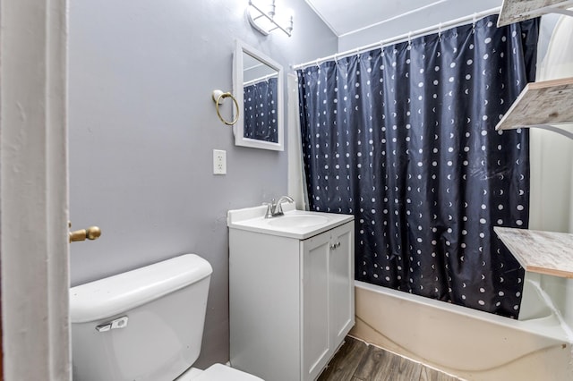 full bathroom featuring hardwood / wood-style floors, toilet, shower / bath combo, and vanity