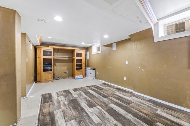 basement with hardwood / wood-style floors