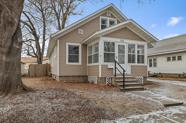 bungalow-style home with a sunroom