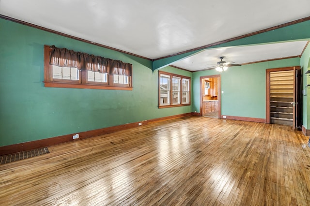 unfurnished living room with hardwood / wood-style flooring, ceiling fan, ornamental molding, and lofted ceiling