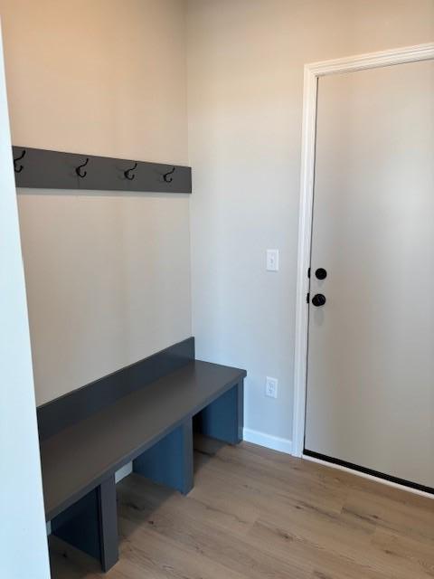 mudroom with baseboards and light wood-style floors