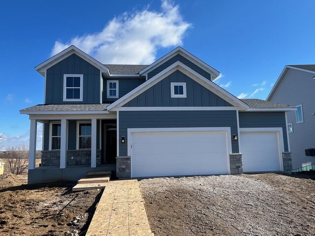 14554 Kingsview Ln N, Dayton, MN 55327 - craftsman house with board and batten siding, covered porch, an attached garage, and roof with shingles