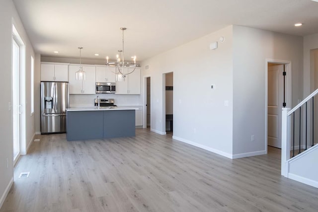 14554 Kingsview Ln N, Dayton, MN 55327 - kitchen featuring stainless steel appliances, a chandelier, light wood-type flooring, white cabinetry, and recessed lighting