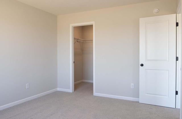 14554 Kingsview Ln N, Dayton, MN 55327 - unfurnished bedroom featuring light colored carpet, baseboards, a walk in closet, and a closet