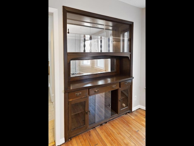 bar featuring light hardwood / wood-style floors