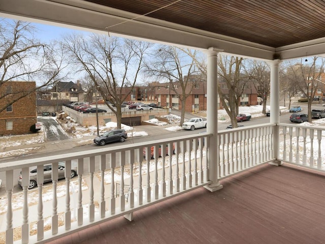 snow covered deck with covered porch