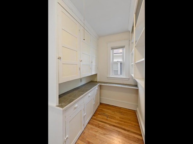 interior space featuring white cabinetry and light wood-type flooring