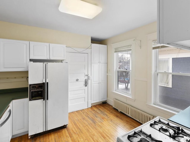 kitchen featuring white cabinetry, white appliances, and light hardwood / wood-style floors