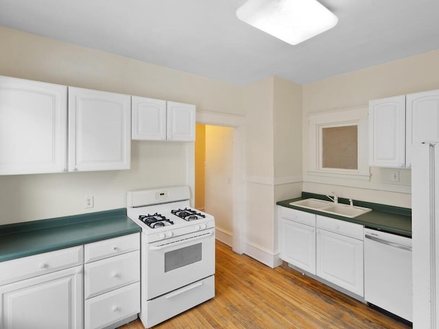 kitchen with white cabinetry, sink, white appliances, and light hardwood / wood-style floors