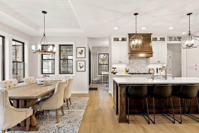 kitchen with pendant lighting, sink, and a kitchen island with sink