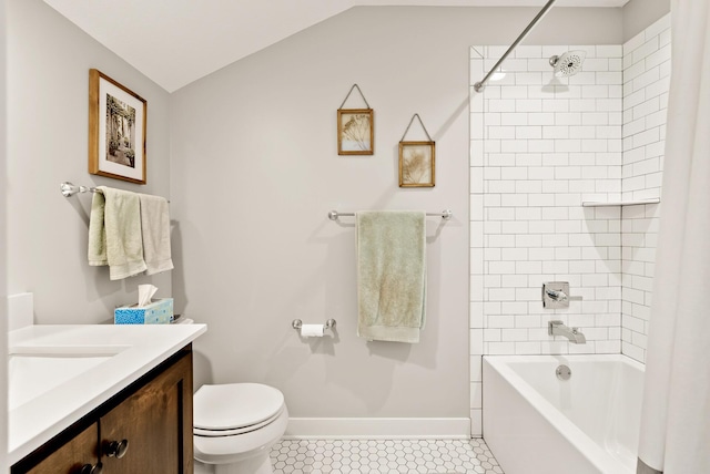 full bathroom with vaulted ceiling, tiled shower / bath, tile patterned flooring, vanity, and toilet