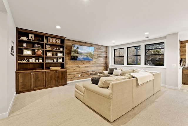 carpeted living room with wooden walls