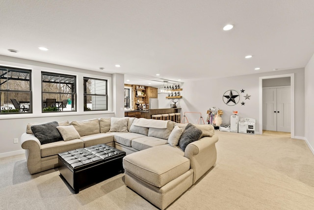 living room with light colored carpet and bar