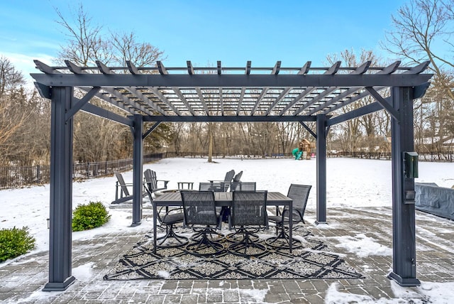 snow covered patio featuring a pergola