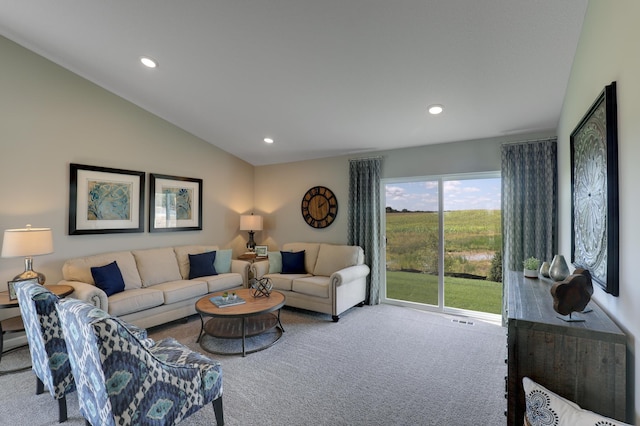 carpeted living room with lofted ceiling