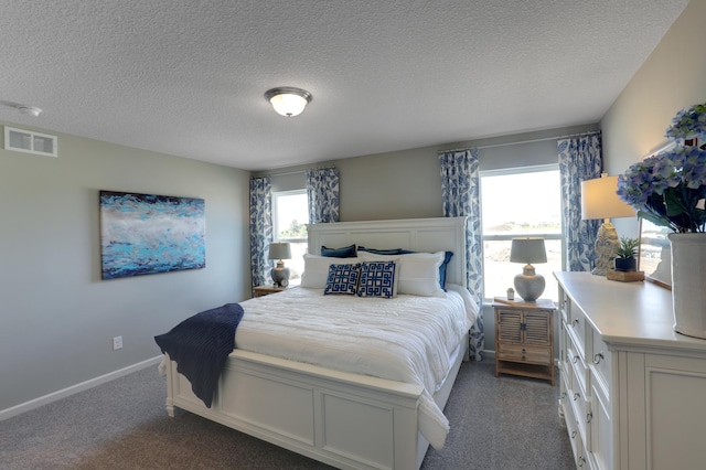 carpeted bedroom featuring a textured ceiling