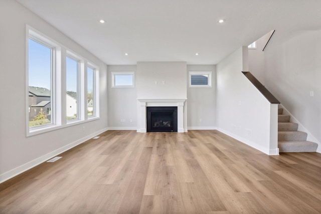 unfurnished living room with light hardwood / wood-style floors