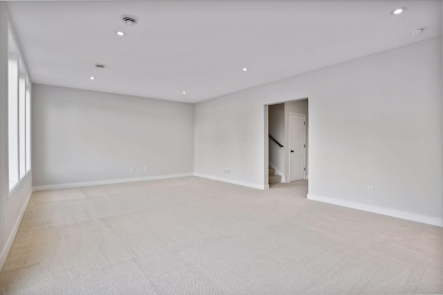 unfurnished room featuring light colored carpet