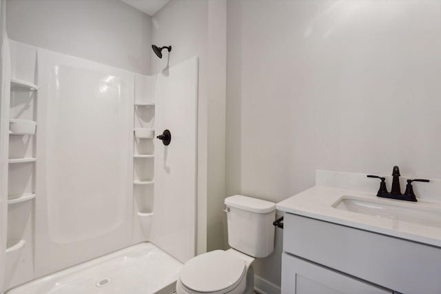 bathroom with walk in shower, vanity, and toilet