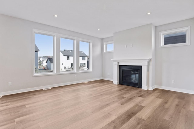 unfurnished living room with light hardwood / wood-style flooring