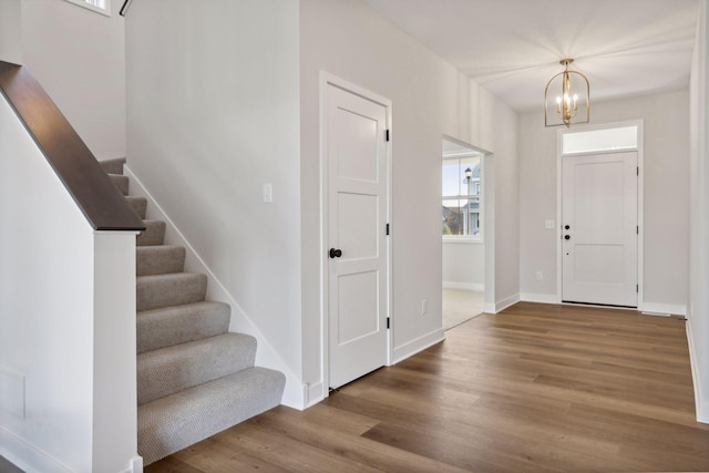 foyer featuring hardwood / wood-style floors and an inviting chandelier