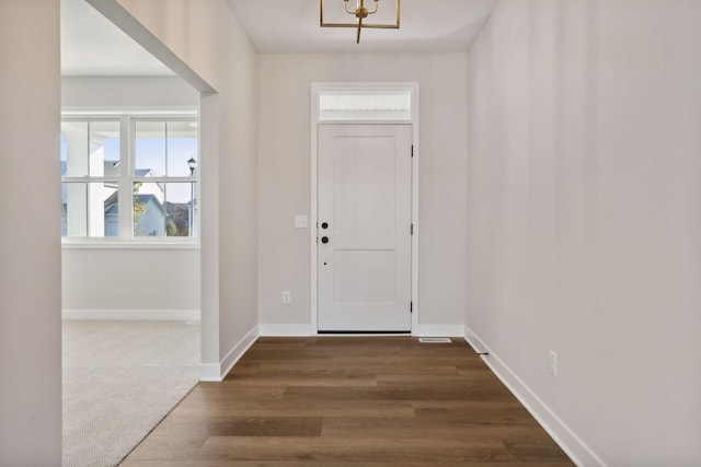 foyer with dark hardwood / wood-style flooring