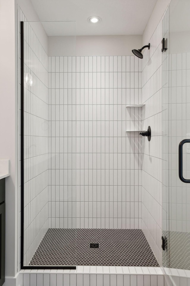 bathroom with an enclosed shower and vanity