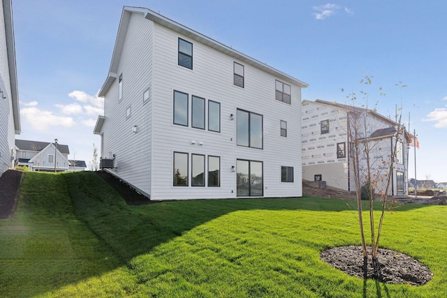 rear view of house with a yard