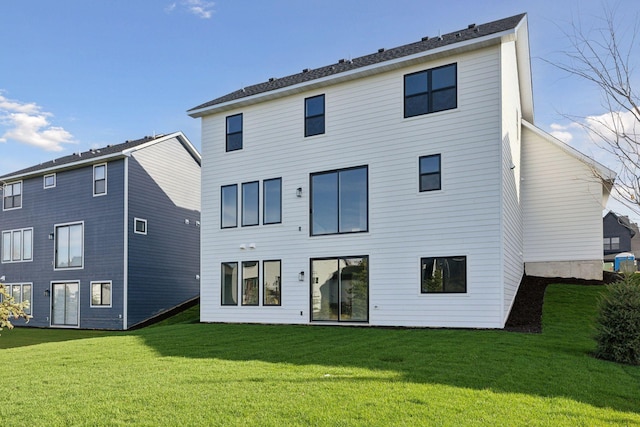 back of house with a lawn