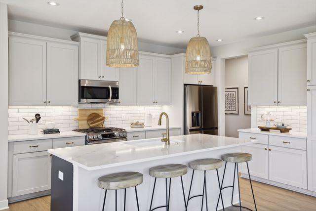 kitchen featuring white cabinetry, a kitchen island with sink, and appliances with stainless steel finishes