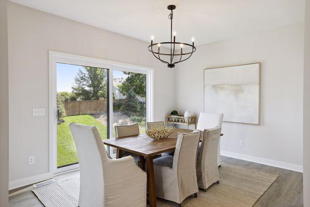 dining space featuring hardwood / wood-style flooring and a chandelier