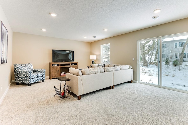 living room featuring light colored carpet and a textured ceiling