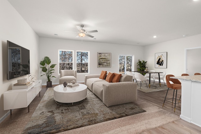 living room with baseboards, ceiling fan, wood finished floors, and recessed lighting