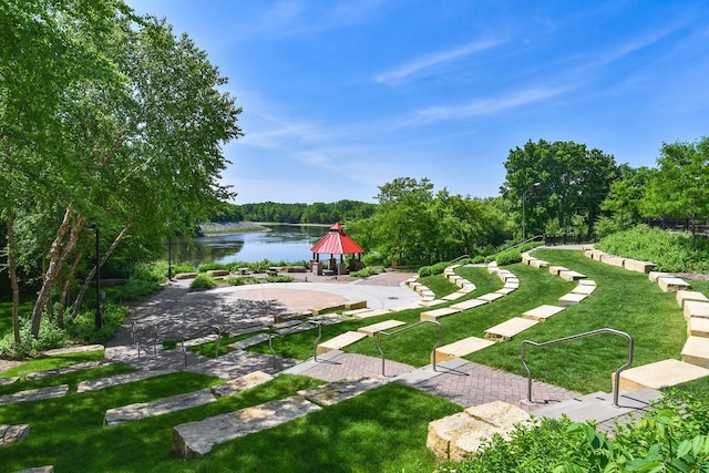 view of home's community featuring a water view and a yard