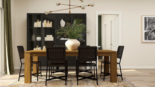 dining area with baseboards, wood finished floors, and a chandelier