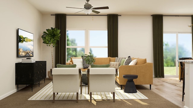 dining space with wood finished floors, baseboards, and ceiling fan