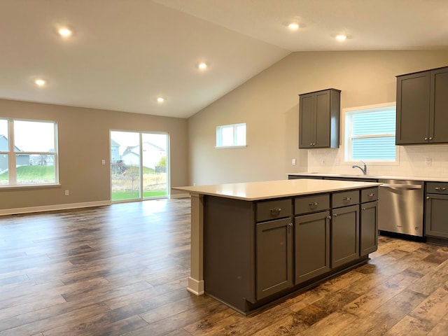 kitchen featuring a center island, stainless steel dishwasher, dark hardwood / wood-style flooring, and gray cabinetry