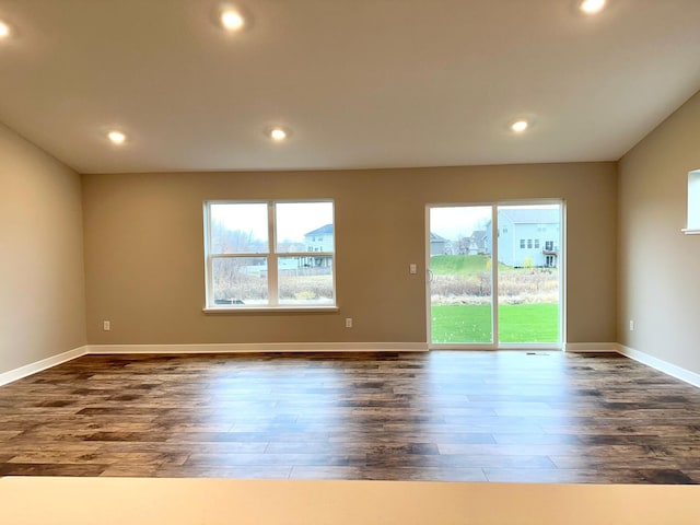 spare room with dark hardwood / wood-style flooring